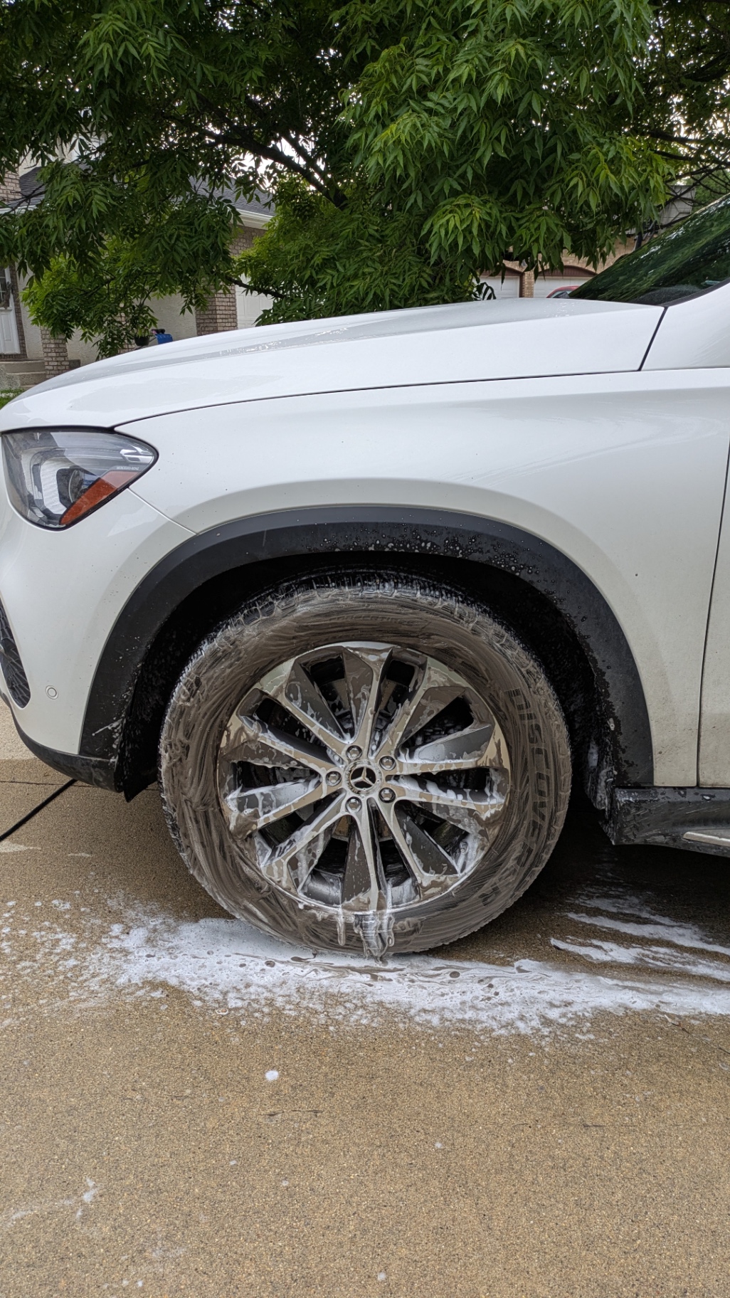 GLE wheel deep in snow-foam, brake dust dissolving