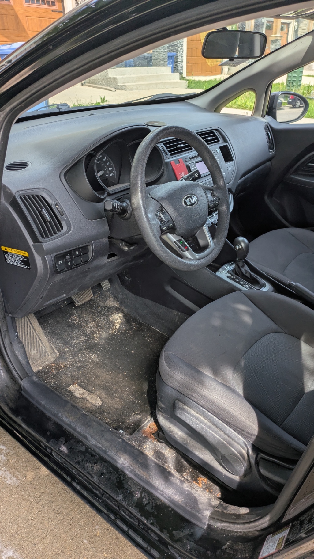 Kia Rio driver side, dirt and debris ground into the carpet