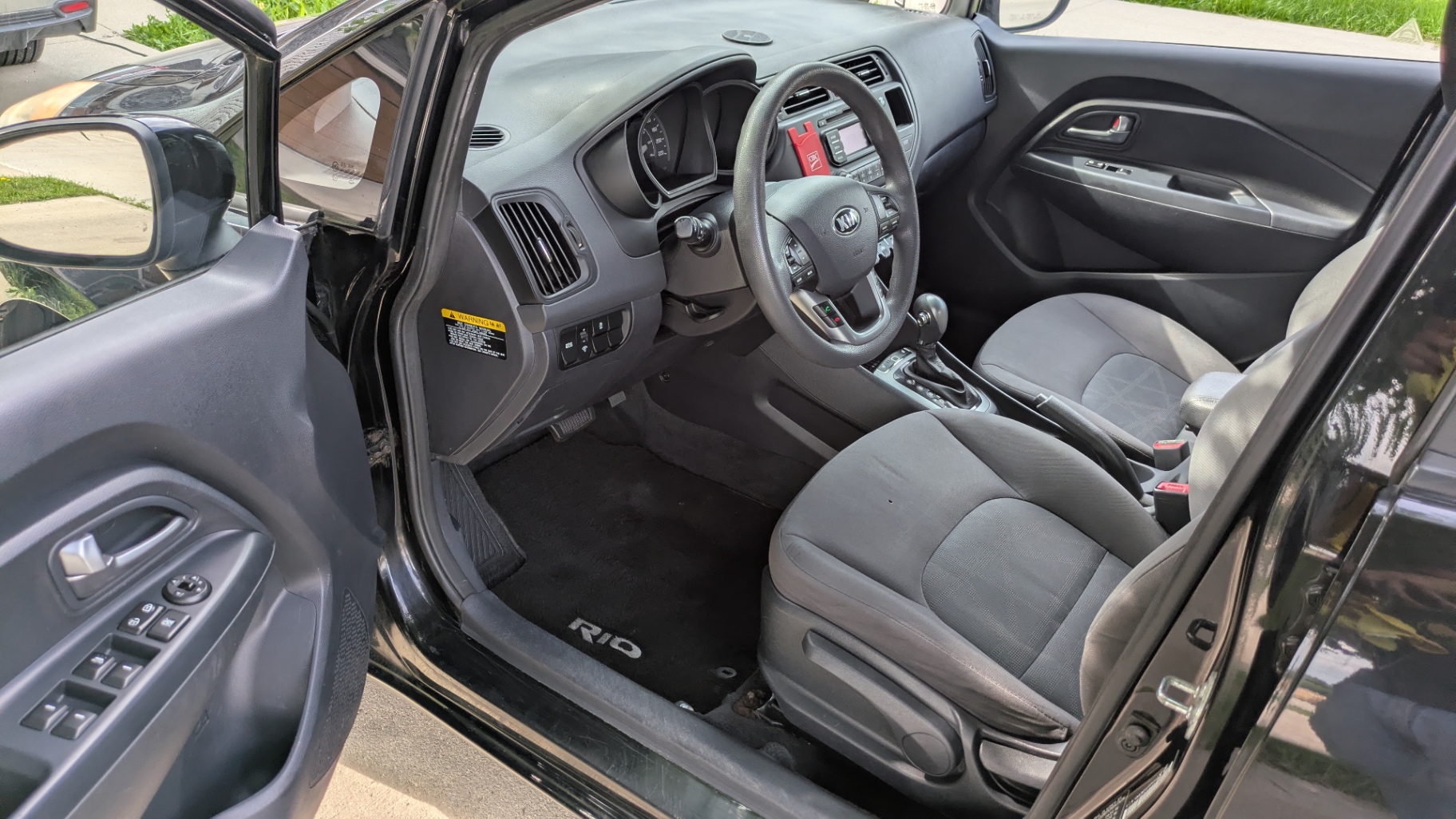 Same Kia Rio driver side, carpets and trim like new